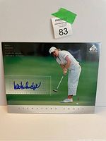 Photo of the signed golf photo showing Kelli Kuehne putting and the autograph.