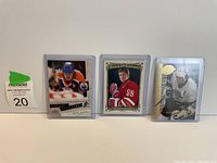 Photo of 3 Wayne Gretzky hockey cards showing different designs and teams.