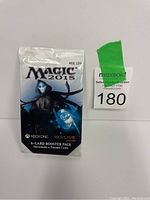 Sealed Magic: The Gathering 2015 booster pack with seller lot tag