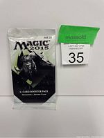 Sealed Magic 2015 6-card booster pack with promo card in black and white packaging featuring dragon artwork