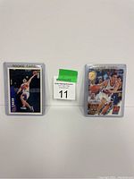 Two Steve Nash rookie basketball cards in protective plastic holders, one serial numbered 154/500.