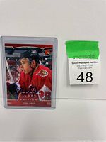 Front view of Todd White autographed hockey card in plastic protective case with seller auction tag beside it.