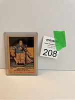 Front view of vintage Turk Broda hockey card in protective holder showing player in goalie gear.