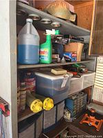 Photo of five shelves filled with hardware, garden chemicals, cleaning supplies including Windex, storage bins, safety glasses, and boxes including one labeled Ryobi.