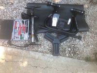 LeMond indoor bike trainer stand, Trakstand trainer frame, air pump, and a black mat on the ground.
