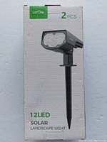 Front view of boxed Litom 12 LED Solar Landscape Lights showing quantity of 2 pieces and product details.