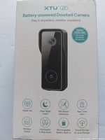 Front view of the XTU J7 battery-powered doorbell camera packaging showing key features like 1080P HD, night vision, PIR motion detection, and wireless operation.
