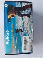 Photo of the front of the Flyhare heated socks box showing imagery of people in winter gear walking on ice or snow.