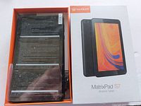 Photo of Vankyo MatrixPad S7 Android tablet inside open box with protective plastic covering on screen.