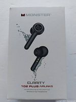 Front of the unopened Monster Clarity 102 Plus Airlinks wireless in-ear headphones box showing earbuds and charging case design with water splash graphics.