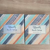 Two Bffbeauty Rock Soap bars in colorful striped packaging