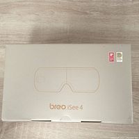 Front view of the Breo iSee4 eye massager box with minimalist artwork and branding.