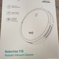 Photo of the front of the Eufy RoboVac 11S box showing product features including ultra-thin design (2.85 in / 72.5 mm), super-strong suction power, and Intelligent BoostIQ technology.