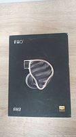Closed box of Fiio FH7 earphones with image of earphones and Hi-Res Audio logo.