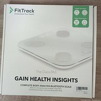 Front of the retail box showing FitTrack logo, product name The Dara BMI, and key phrases: Gain Health Insights, Complete Body Analysis Bluetooth Scale.