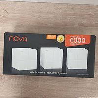 Front of box showing 3-pack of white cube mesh WiFi units and coverage area up to 6000 sq ft with brand Nova and system name.