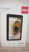 Front of box showing RCA Voyager Tablet with 7-inch display and specs including 2 GB RAM and 16 GB storage.