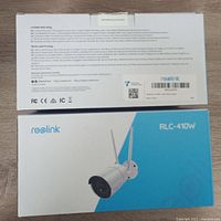 Top and bottom of the box showing Reolink branding, RLC-410W model, and certification marks.