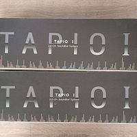 Photo of two boxed Tapio I 2.0 CH soundbar systems with brand and model name visible on packaging.