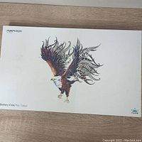 White box with detailed eagle artwork labeled Huion Inspiroy H1060P battery-free pen tablet.