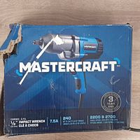 Mastercraft impact wrench boxed with specifications visible showing 7.5A, 240 ft-lb torque, corded design with 3-year warranty.