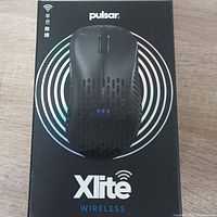 Pulsar Xlite Wireless Mouse in packaging, front view showing branding and mouse image.