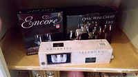 Three boxes of glassware stacked on a shelf showing brand names and product types.