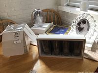 Overview of two Mikasa glass sets in original boxes with three frames around