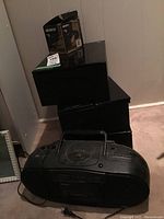 Samsung black portable stereo boombox with visible buttons, speaker grills, cassette player, power cord, and brand name.