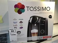 Front view of Bosch Tassimo T47 box showing product image and multiple compatible brands.
