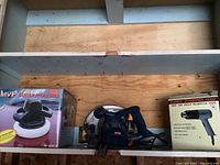 Shelf with MVP buffer polisher box, Ryobi circular saw and Super Stripper heat tool box