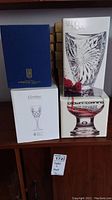 Boxes stacked showing Studio Nova vase, Crown Corning, Cartier, and Cortina glassware brands