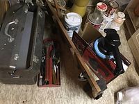 Photo showing two metal toolboxes, manual grass edger, measuring tape, mallet, screwdrivers, and Craftsman car buffer polisher in box.