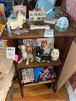 Top view of wooden shelf with various dog figurines, signs, and grooming items