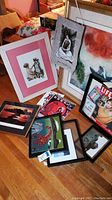 Photo showing framed child painting, tapestry with rabbit, and abstract art print with LIFE magazine cover and vintage magazines on floor