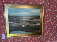 Full-frontal view of the framed aerial farmland painting