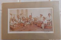 Frontal photo of the matted and sealed watercolor print showing seven Malay traditional musicians playing instruments seated on the ground in traditional dress.