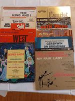 Photo showing nine LP record covers of original Broadway cast recordings and classic show tunes.