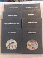 Photo of 10 hardcover Time-Life books from 'The Epic of Flight' series with black covers and white text on aviation subjects.