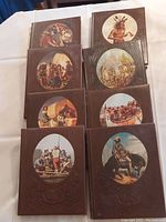 View of the eight hardcover books of The Old West series with embossed brown covers and oval illustrated vignettes showing historic western scenes.