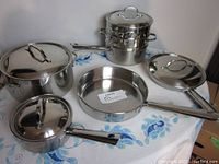 Full overview of all cookware pieces arranged on table