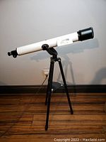 Full view of TASCO telescope mounted on tripod.