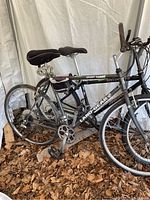 Side view of the black Land Gear mountain bike showing overall frame, tires, seat, and handlebar.