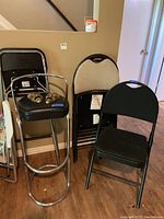 View of the lot showing stools and folding chairs against wall with wooden floor
