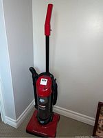Full view of red Dirt Devil Dynamite Plus upright vacuum cleaner.