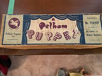 Original box for Mr. Turnip puppet featuring Pelham Puppets Ltd. branding and decorative artwork.
