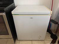 Front view of white Master Chef chest freezer showing control knob and brand label