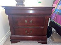 Front view of the wood night stand showing the two drawers with brass handles and overall polished dark finish.