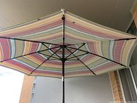 Striped outdoor umbrella attached to table