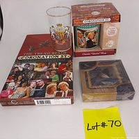 Photo showing the Coronation Street book, Classic Quote Mug in original box, Pimpernel coasters in original packaging, with a yellow lot 70 tag.